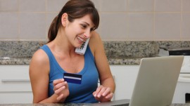 woman shopping online, talking on the phone woman shopping online, talking on the phone
